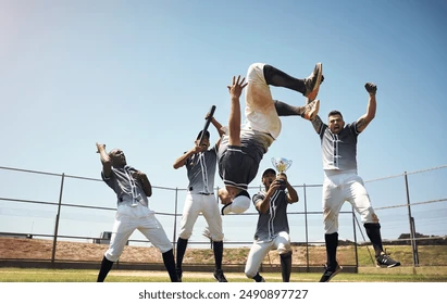 Baseball field, men and team in celebration, success and backflip for goals, performance or winning. People, group and diversity with support, summersault or happy on pitch for competition in Boston Stock Photo